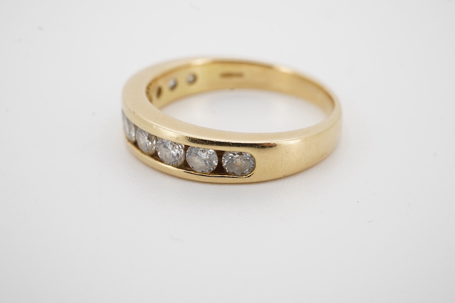 A modern 18ct gold and ten stone channel set diamond half hoop ring, size Q, gross weight 5.8 grams. Condition - fair to good